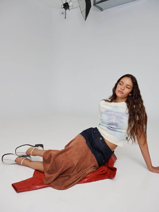 Women's cream heel worn with a tan skirt