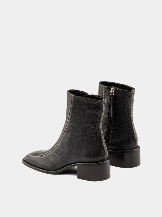 Black ankle boot with white stitching and square heel