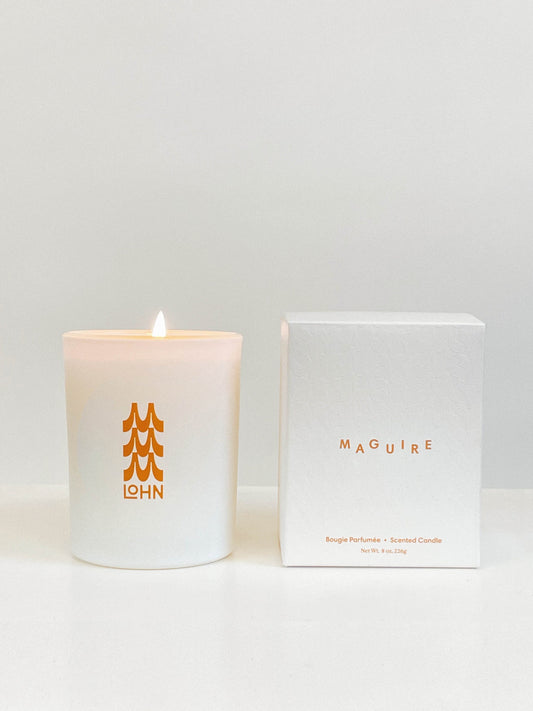 Maguire X Lohn candle on a white background with the box