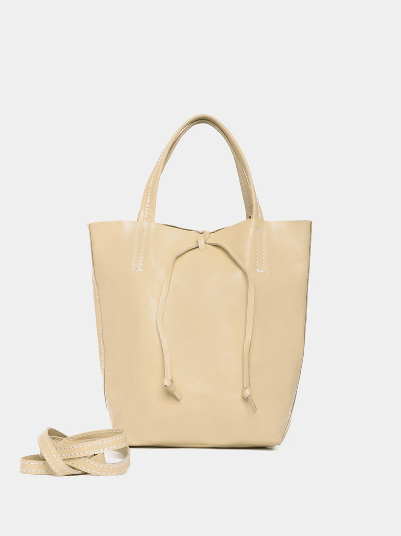 Butter coloured mini leather toate bag with a crossbody strap