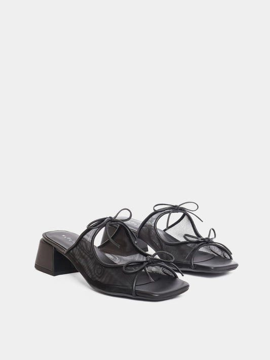 Black sandals with a block heel on a white background