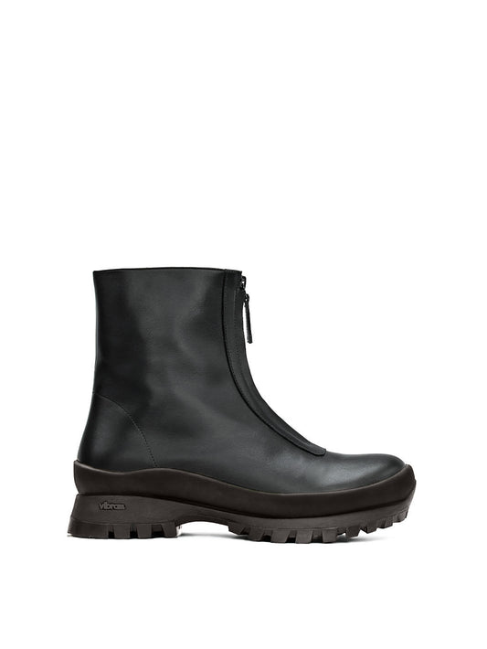 Black fur-lined boot with a zipper going down the middle and a black vibram sole