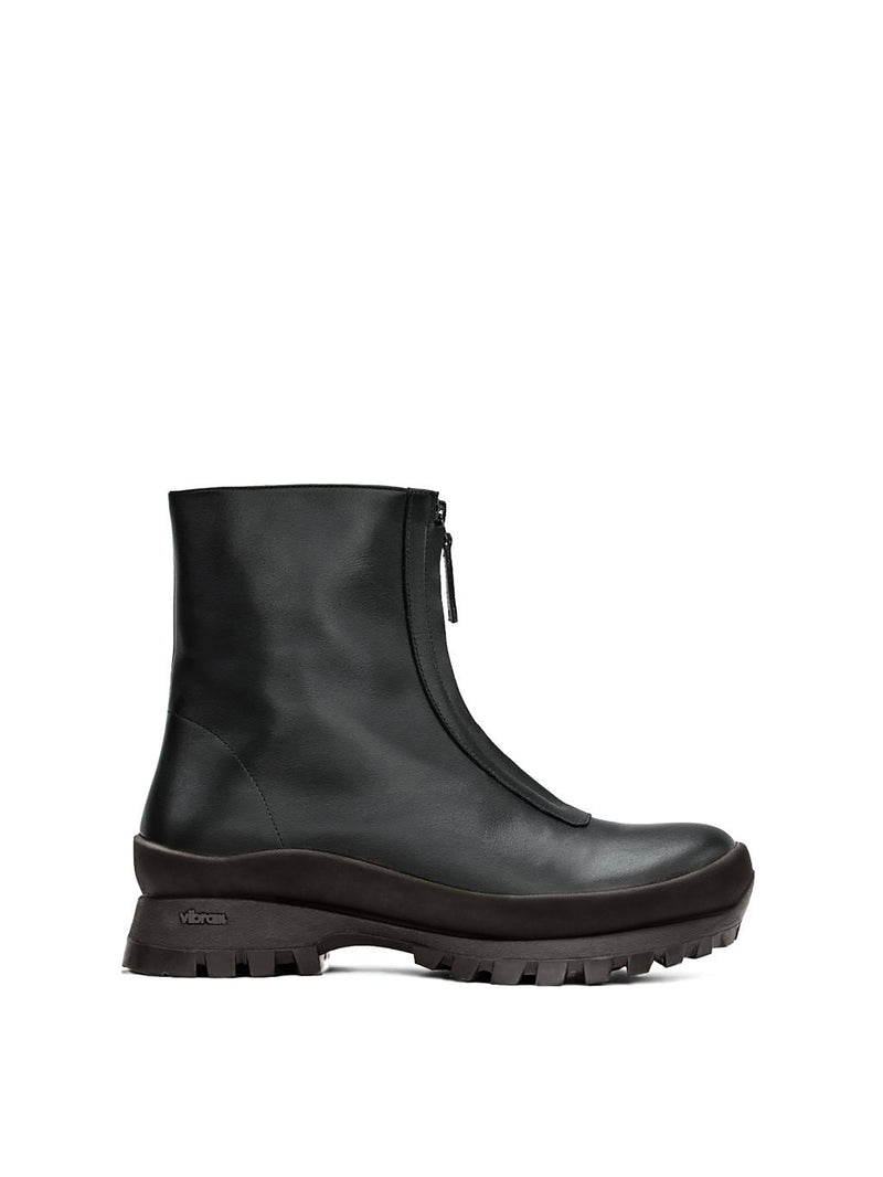 Black fur-lined boot with a zipper going down the middle and a black vibram sole
