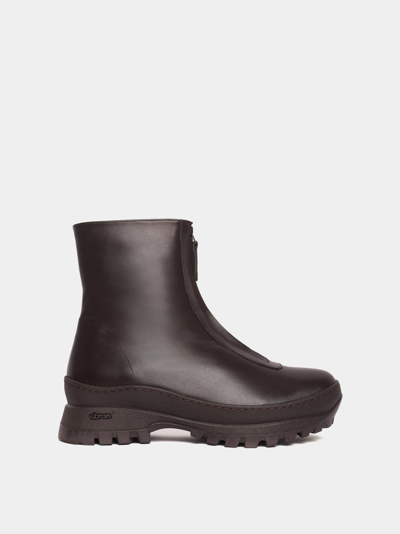 Brown fur-lined boot with a zipper going down the middle and a brown vibram sole