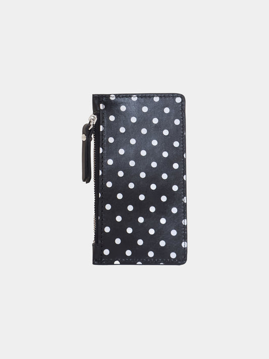 Black zippered pouch with white polka dots on a light gray background