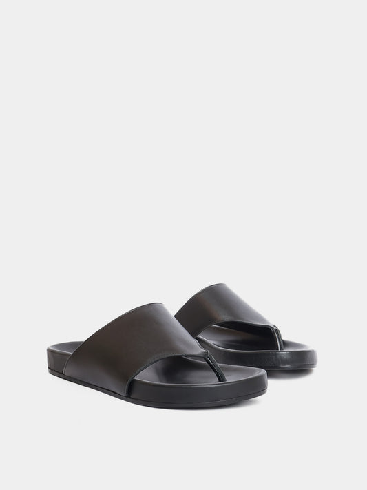 black flip flop on grey background