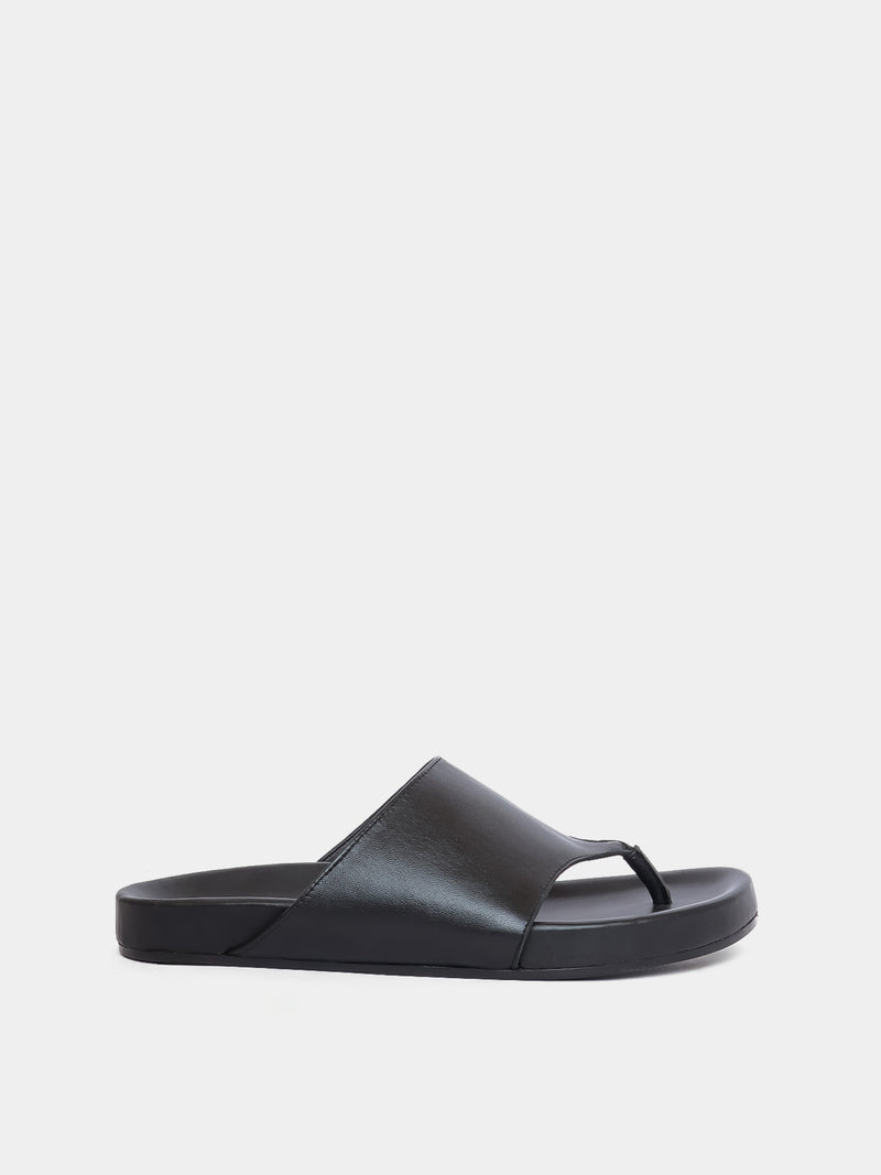 black flip flop on grey background
