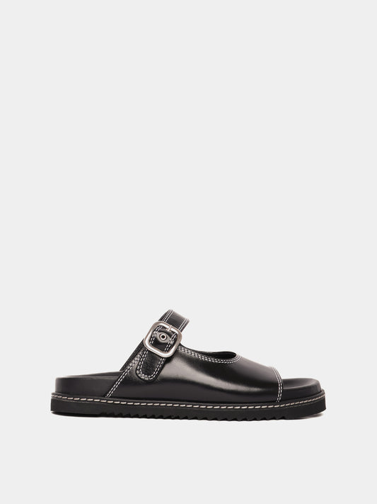 A black sandal with an adjustable buckle strap and a flat sole.