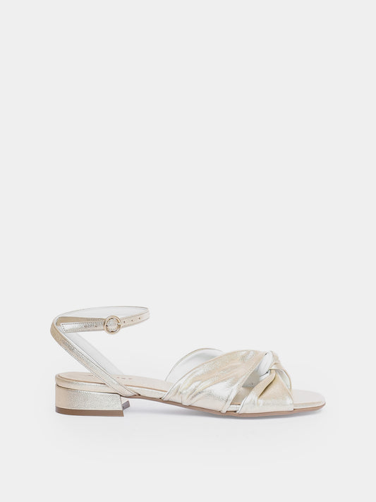 gold sandal on light gray background