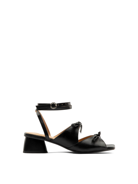 Mira black leather square-toe heel with ankle strap and two bows, side view.
