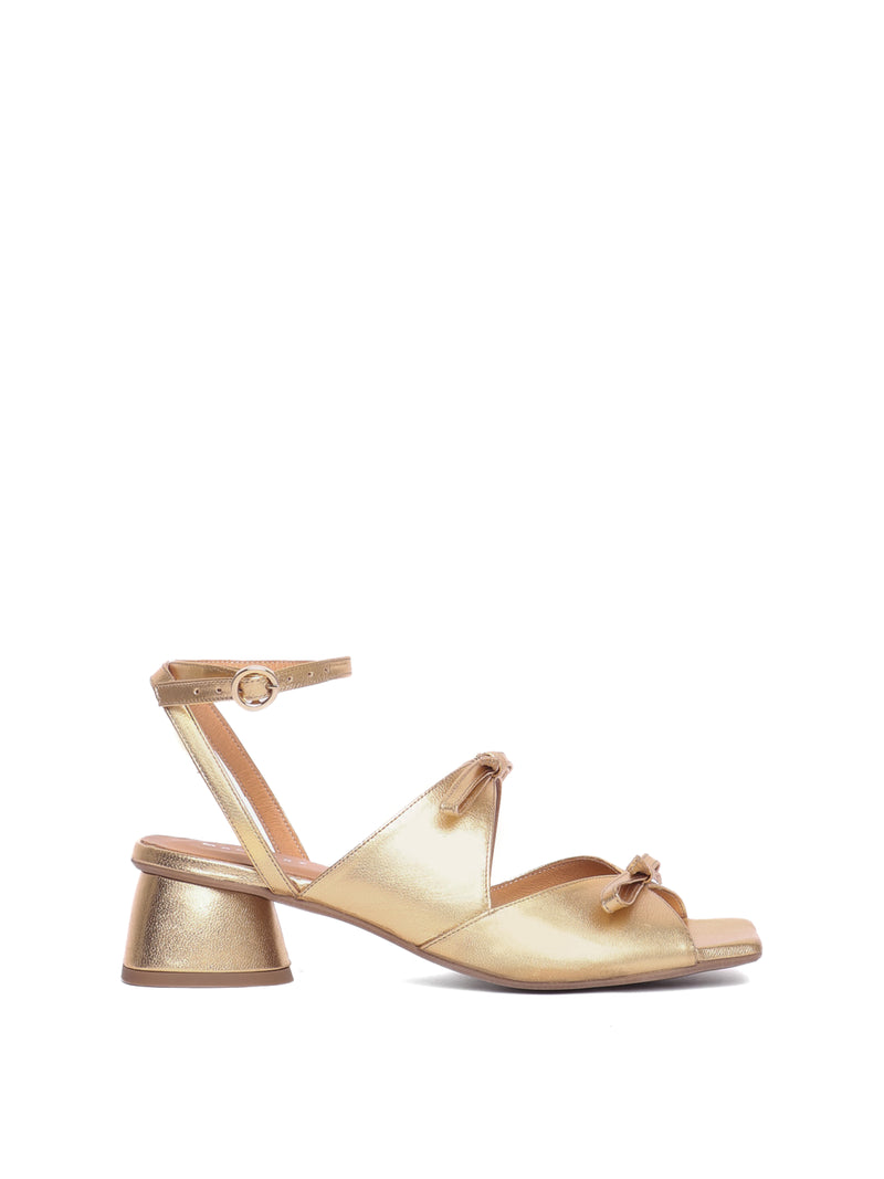 Gold leather heel with two straps adorned with bows and an ankle strap