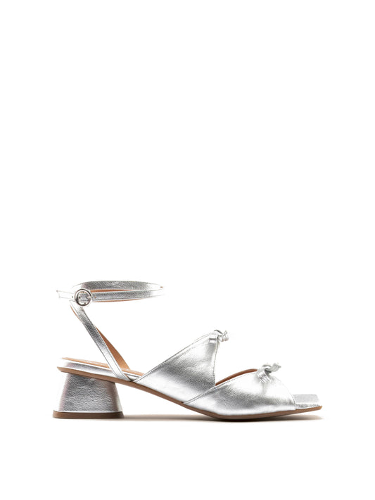 Silver healed sandal with ankle strap, open toe and two bows.