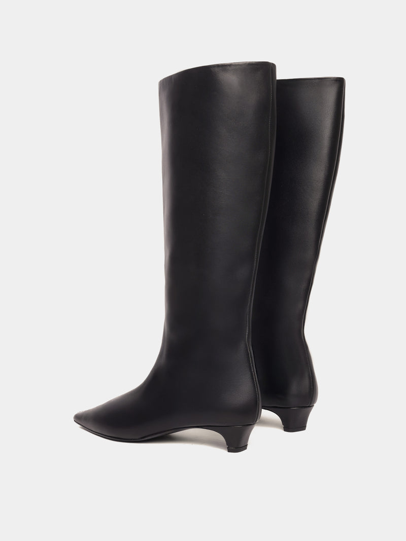 Knee-high black leather boots with a low heel and pointed toes