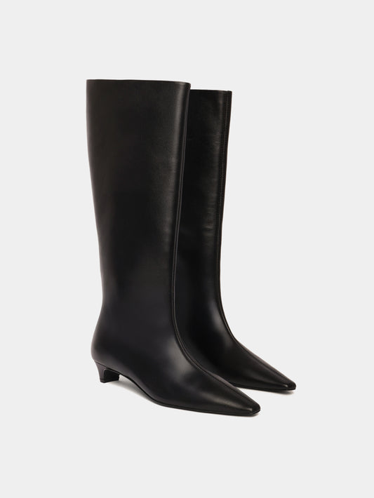 Knee-high black leather boots with a low heel and pointed toes