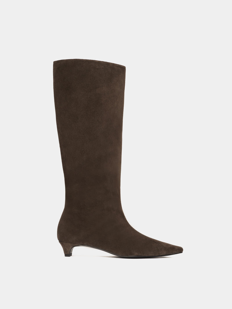 Knee-high brown suede boots with a low heel and pointed toes