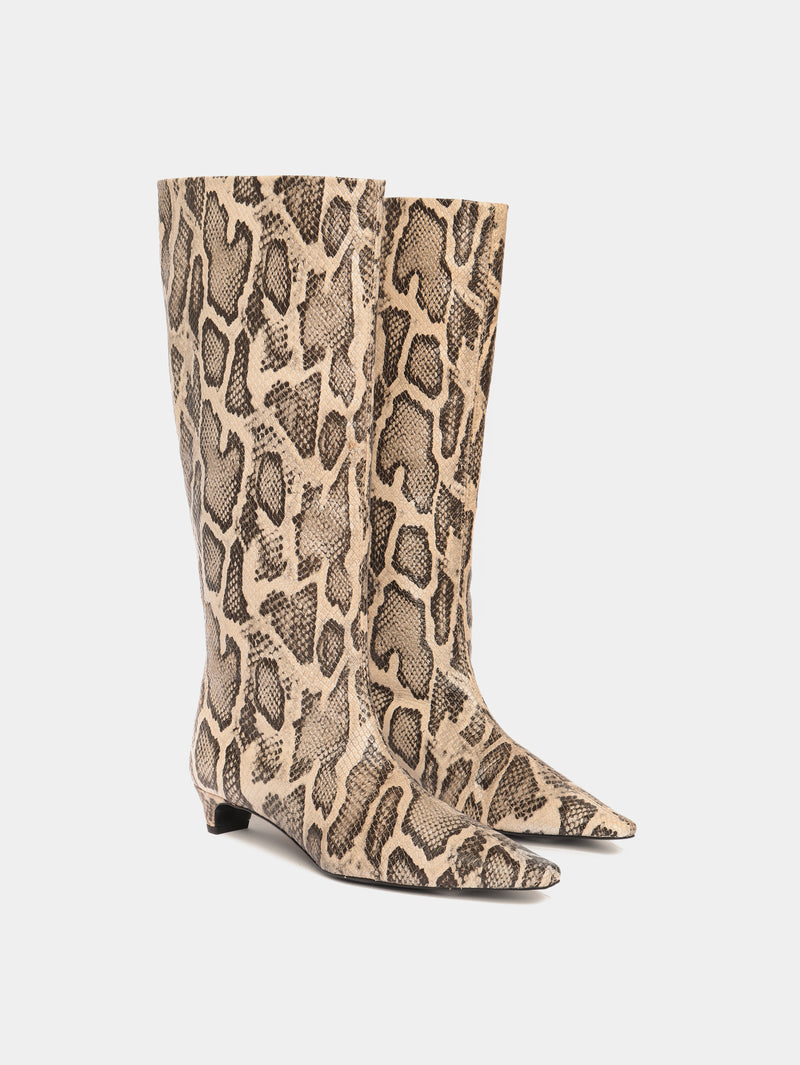 Knee-high snake pattern leather boots with a low heel and pointed toes