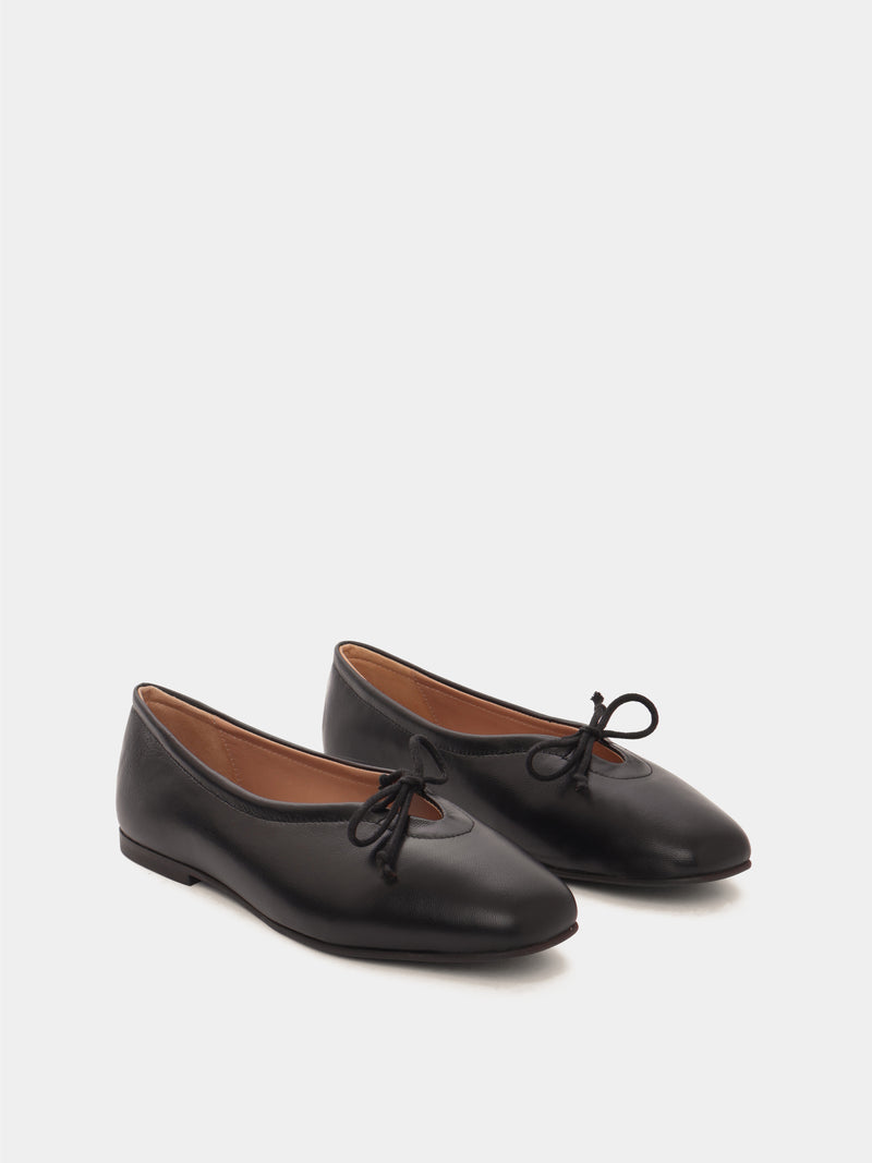 Black leather ballerina flats with a black bow