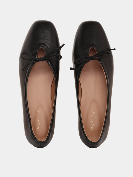 Black leather ballerina flats with a black bow