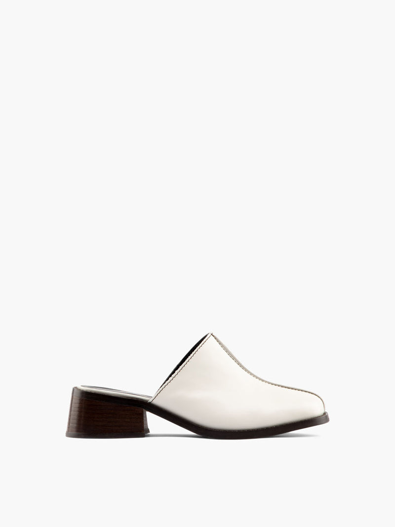 Safara Cream mule with a low heel and open back.