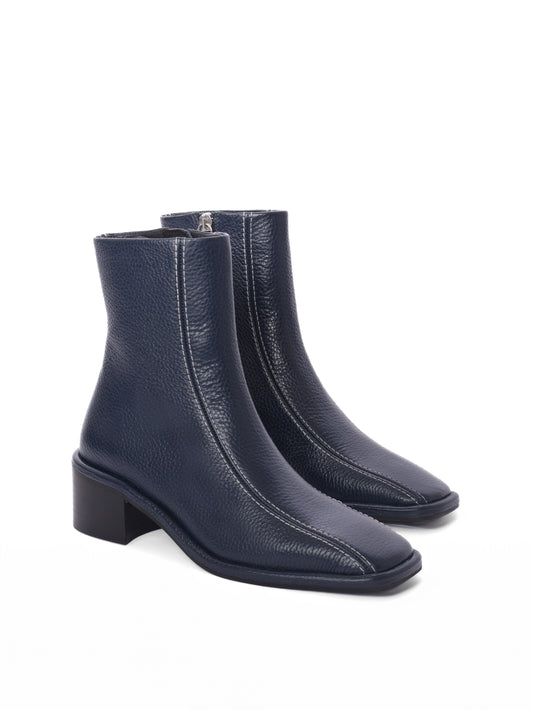 Navy leather ankle boots with white contrast stitching and a block heel