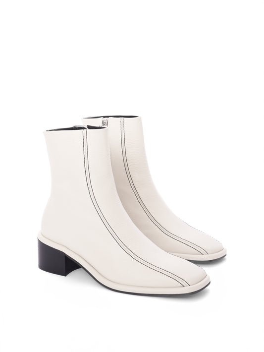 Cream leather ankle boots with black contrast stitching and a block heel