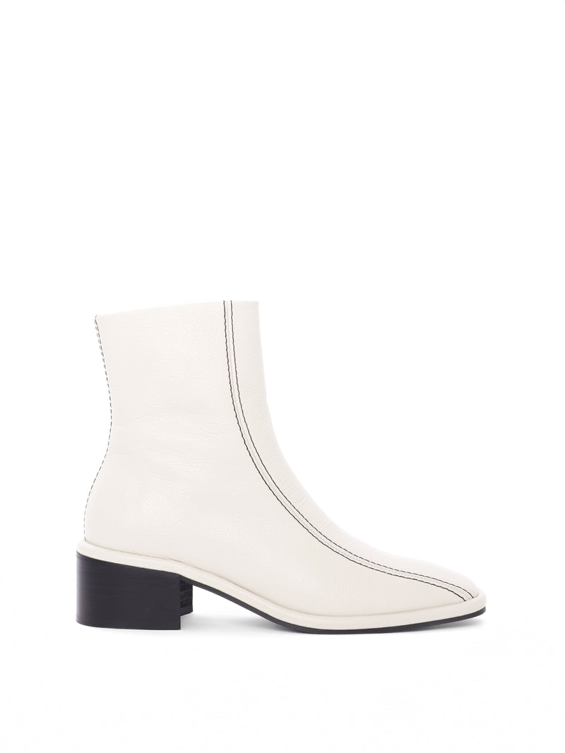 Cream leather ankle boot with black contrast stitching and a block heel