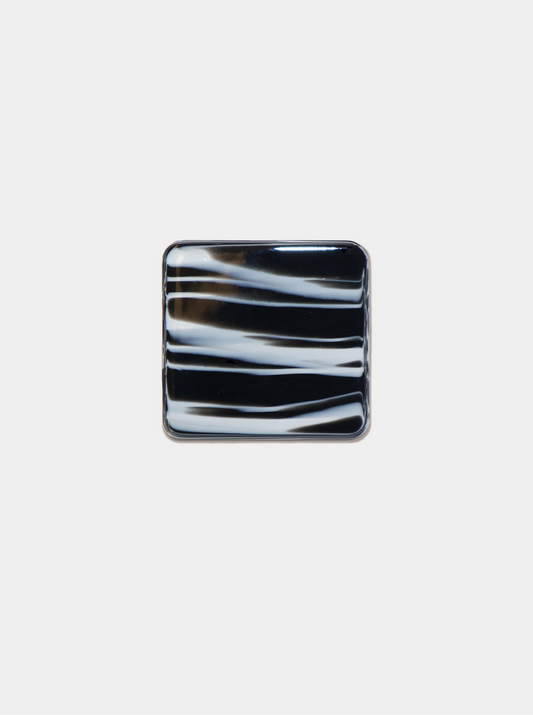 Ecom image of square shoe clip, black with white paint-like strokes