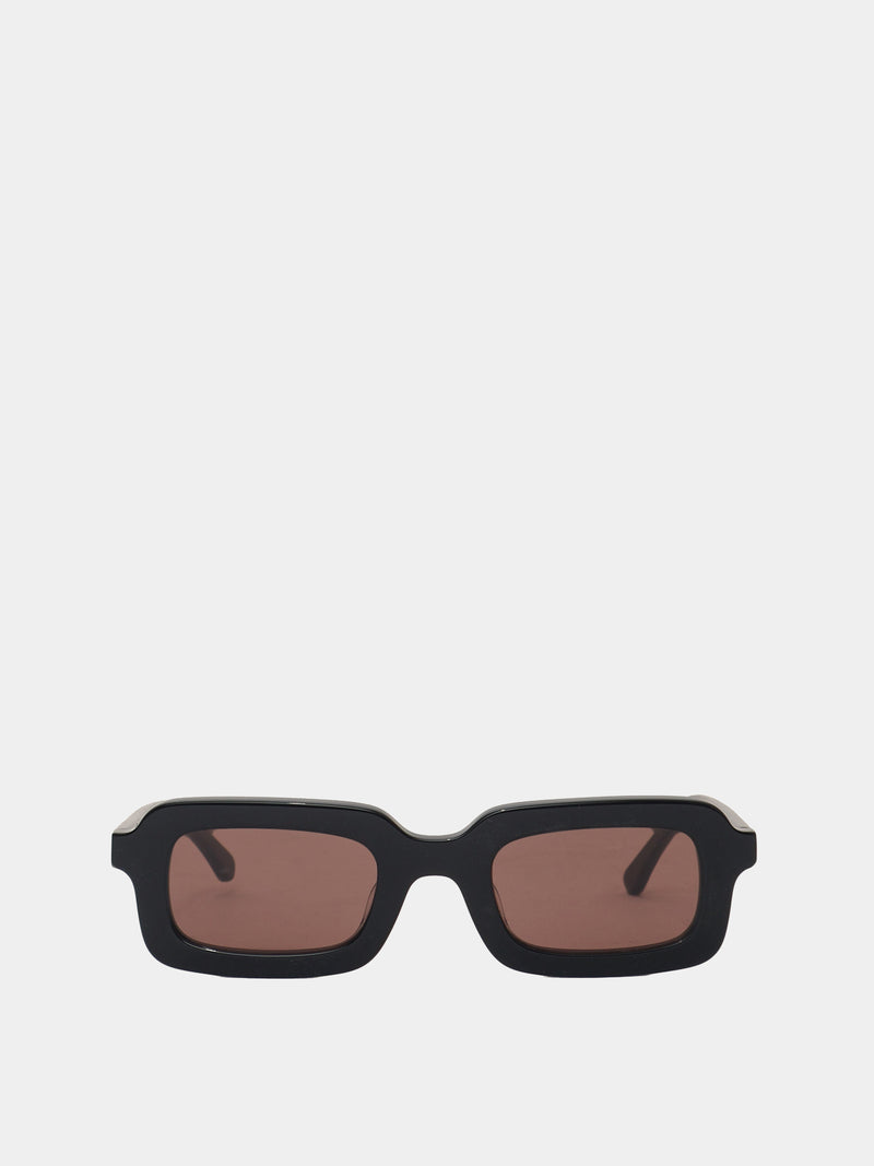 Rectangle shaped sunglasses in a black plastic colour with a brown lens. 