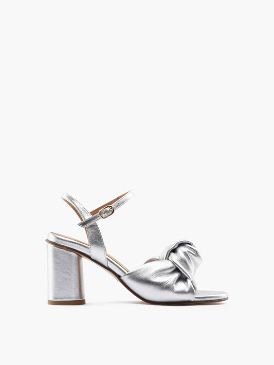 Silver high-heel with an ankle strap and leather knot
