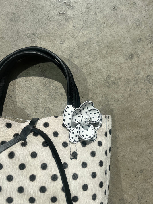 White and black polka dot flower clip on white and black polka dot bag