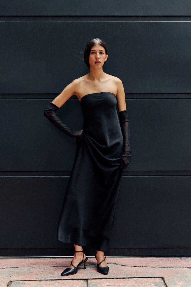 Woman in black dress wearing black heels
