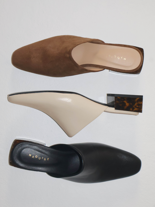 Three pairs of shoes in brown, beige, and black on a light gray background.