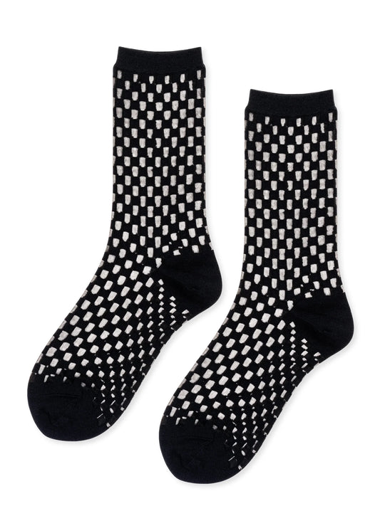 Black socks with white geometric pattern on a white background