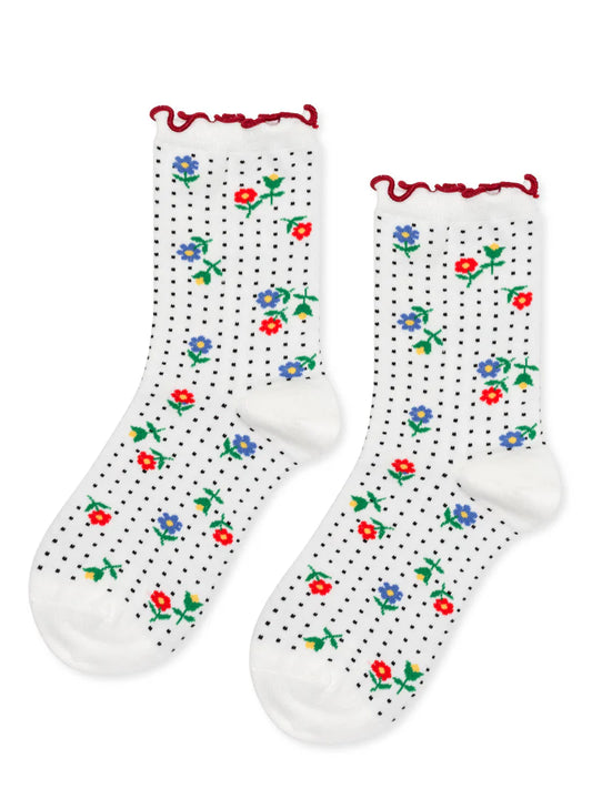White socks with floral patterns and red trim on a white background